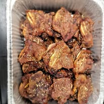 A tray of grilled marinated meat